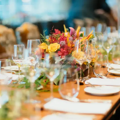 Elegant dining setup with floral centerpiece, glassware, and neatly arranged table settings for event catering in Pittsburgh.